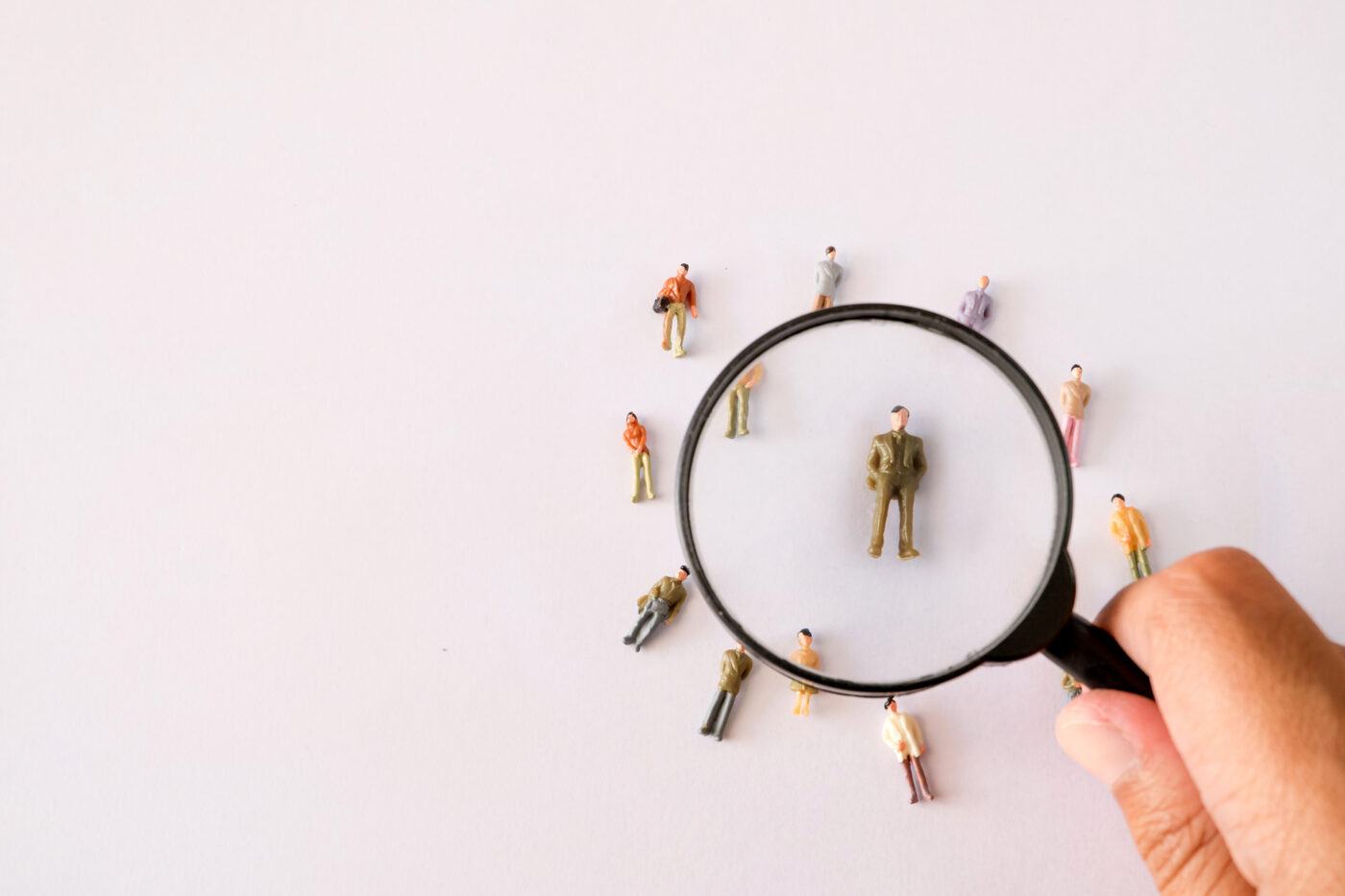 Magnifying glass on an individual (candidate) to demonstrate insightful recruitment